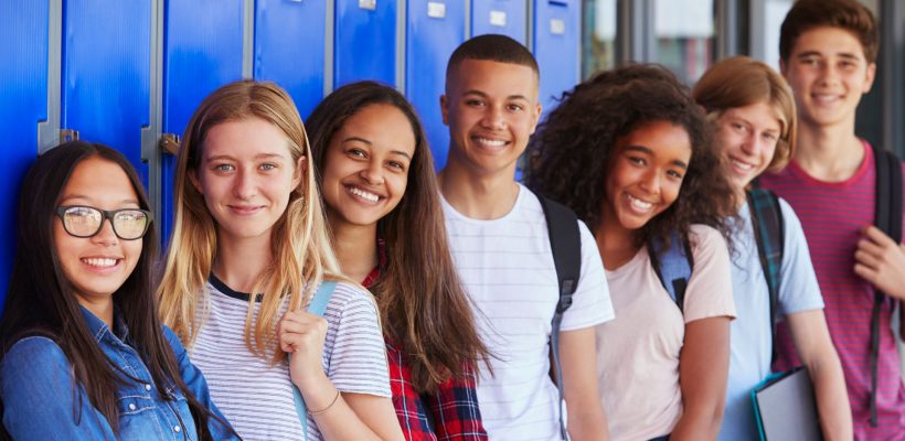 Group of youth standing in front of lockers