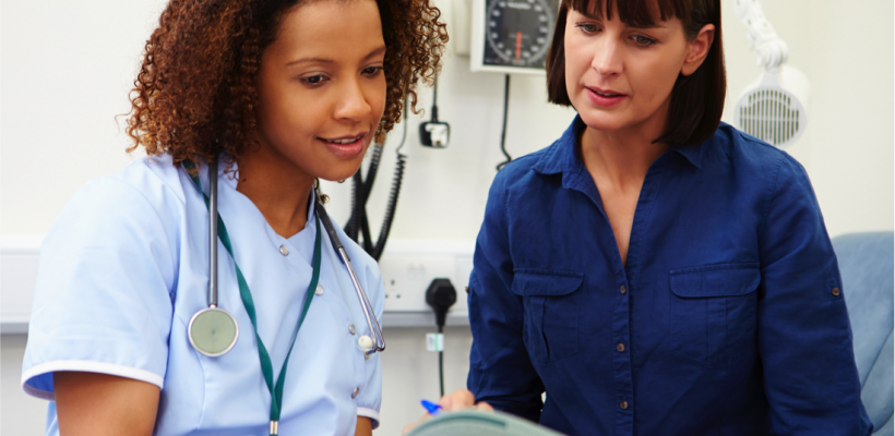 Female nurse talking to female patient