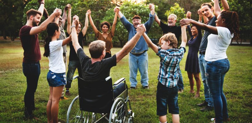 Group of people holding hand together in the park