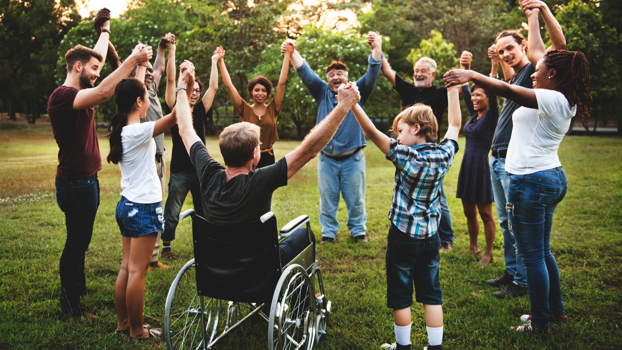 Group of people holding hand together in the park
