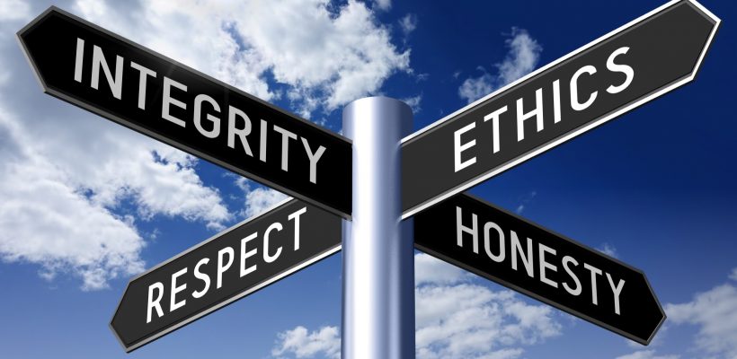 Metal signpost with four arrows, "integrity", "ethics", "respect", "honesty" words on them, blue sky with clouds and sun in a background.